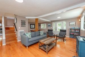a living room with a couch and a table at Smooth Sailing by Railey Vacations in Swanton