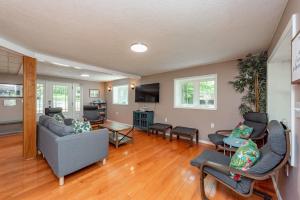 a living room with a couch and a table at Smooth Sailing by Railey Vacations in Swanton +34 photos