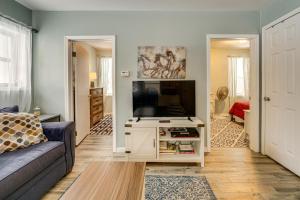 a living room with a couch and a flat screen tv at Woodsy & Charming! Applegate Cabin w/ Large Yard in Applegate