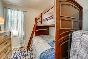 a bedroom with two bunk beds and a dresser at Woodsy & Charming! Applegate Cabin w/ Large Yard in Applegate
