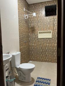 a bathroom with a toilet and a sink at CasAnita in Cavalcante +2 photos