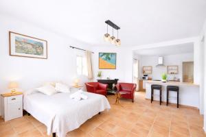 a white bedroom with a bed and a desk at Finca Feliciano in Novo Sancti Petri +35 photos