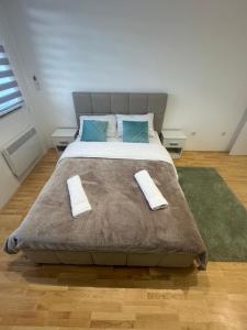 a bedroom with a large bed with two pillows at Apartman "Paolo" Istočno Sarajevo in Vranješ