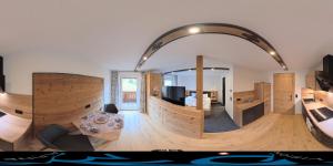 a living room with an arch in the middle of a room at Haus Enzian Apartments in Kartitsch +88 photos