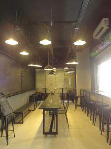 a dining room with tables and chairs and lights at Graffi City House in Florianópolis