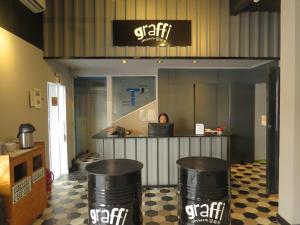 a store with a counter and two trash cans at Graffi City House in Florianópolis