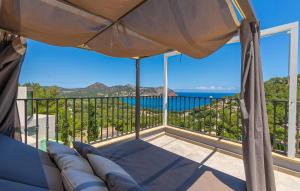 a balcony with a couch and a view of the ocean at Cap Vermell in Canyamel