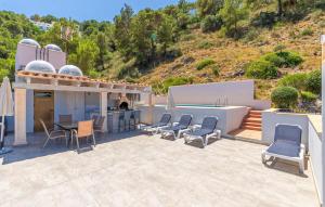 a patio with chairs and a table and a kitchen at Cap Vermell in Canyamel +25 photos