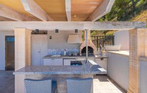 an outdoor kitchen with a table and a grill at Cap Vermell in Canyamel