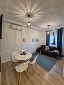 a living room with a table and chairs and a couch at Bitini Farm Apartment in Gračišče