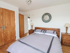 a bedroom with a bed and a mirror on the wall at Lurach House in Appin