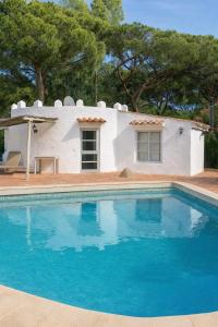 a villa with a swimming pool in front of a house at Finca Feliciano in Novo Sancti Petri
