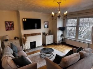 a living room with a couch and a fireplace at 2 bed apartment close to beach in Herne Bay