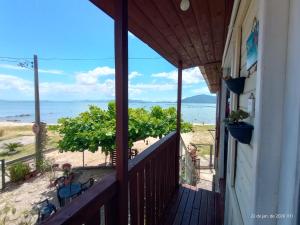 a balcony of a house with a view of the beach at Recanto dos Sabiás in Palhoça +56 photos