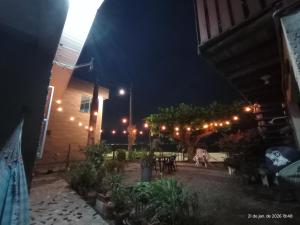 a patio lit up at night with lights at Recanto dos Sabiás in Palhoça
