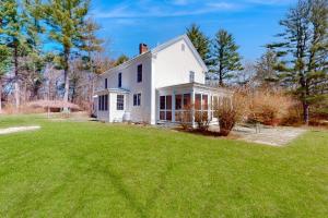 ein weißes Haus mit einem Rasen davor in der Unterkunft Close to Copake Lake! 4-Season Escape w/ Sauna in Copake
