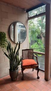 a chair with an orange cushion sitting next to a window at Architectural Gem in Geelong in Geelong +14 photos
