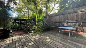 a patio with two chairs and a table and a fence at Architectural Gem in Geelong in Geelong