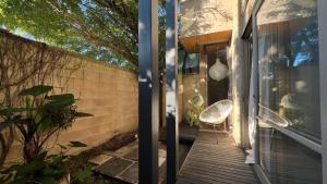 a glass door leading to a porch with two chairs at Architectural Gem in Geelong in Geelong
