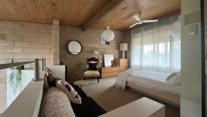 a bedroom with a bed and a desk and a mirror at Architectural Gem in Geelong in Geelong
