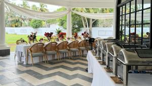 a long table in a room with chairs and tables at Le Palais d'Akwa in Abidjan