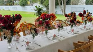 a long table with vases of flowers on it at Le Palais d'Akwa in Abidjan +74 photos