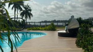 a swimming pool sitting on top of a wooden deck at Le Palais d'Akwa in Abidjan