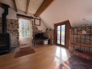 a large living room with a fireplace and a door at Le petit Valet in Saint-Clément