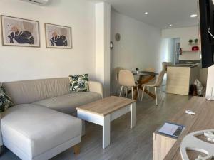 a living room with a couch and a table at Modern Apartment Near Golf, Beach & Marina in San Pedro del Pinatar +14 photos