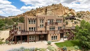 a large house in the middle of a mountain at Slot Canyons Inn Bed & Breakfast in Escalante