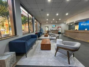 a waiting room with couches and chairs in a hospital at Hotel Monreale Express & Studios IDrive District in Orlando +38 photos