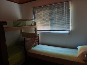 a small room with two bunk beds and a window at Umbral del valle in Valle Hermoso +20 photos