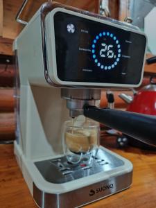 a coffee machine with a cup on top of it at Umbral del valle in Valle Hermoso
