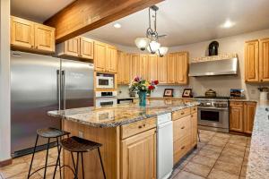 a kitchen with wooden cabinets and stainless steel appliances at Slot Canyons Inn Bed & Breakfast in Escalante