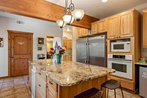 a kitchen with wooden cabinets and a granite counter top at Slot Canyons Inn Bed & Breakfast in Escalante +72 photos