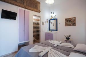 a bedroom with a bed with towels on it at Irini Studios in Psarou