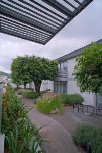 an external view of a building with awning and trees at Hotel Horizon & Convention Center in Morelia