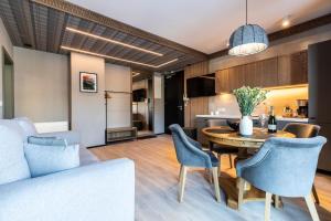 a kitchen and living room with a table and chairs at Gerlach in Zakopane