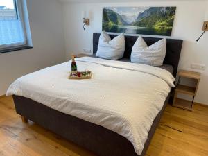 a bedroom with a bed with a bottle of wine on it at "Penthouse Suite" mit Whirlpool Romantik und Privatsphäre in Rosenheim