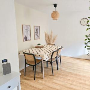 a dining room with a table and chairs at Welcome Home in Royston