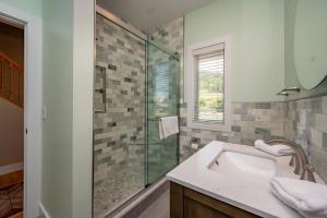 a bathroom with a sink and a glass shower at Apres Ski by Railey Vacations in McHenry
