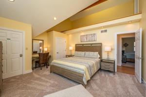 a bedroom with a bed and a desk and a chair at Apres Ski by Railey Vacations in McHenry +51 photos