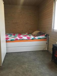 a bed sitting in a corner of a room at Chata Bítov in Bítov