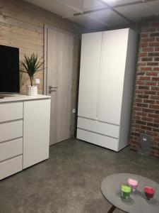 a room with a kitchen with a tv and a table at Chata Bítov in Bítov