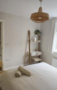 a bedroom with a bed with a towel on it at Welcome Home in Royston