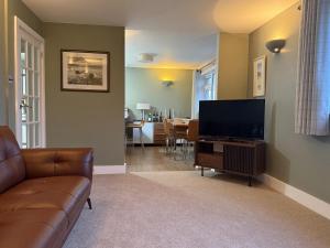 a living room with a couch and a flat screen tv at Sowena in Carbis Bay