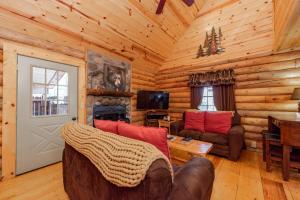 a living room with a couch and a fireplace in a log cabin at Tree Haus by Railey Vacations in Oakland +27 photos