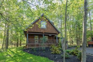 a log cabin in the woods with trees at Tree Haus by Railey Vacations in Oakland
