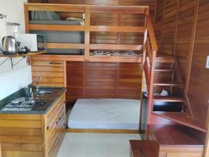 a kitchen with a bunk bed in a room at Pousada Anabela in Campo Alegre