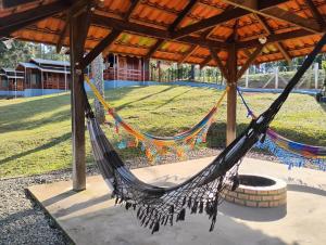 a hammock in a pavilion in a park at Pousada Anabela in Campo Alegre